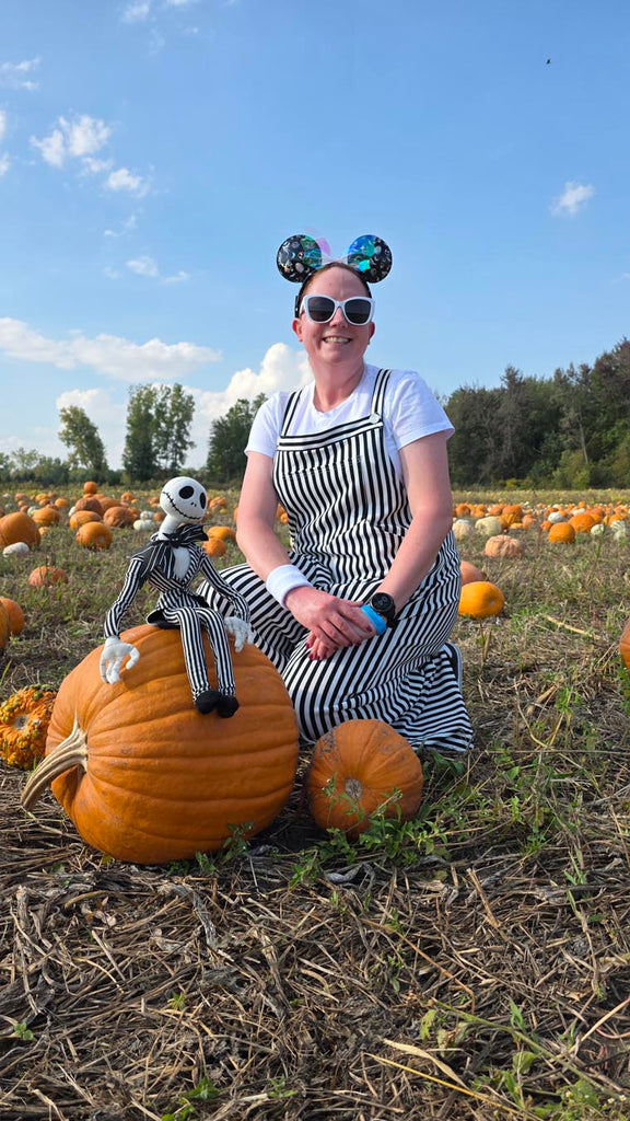 Kelly bounding as Jack Skellington while in a pumpkin patch