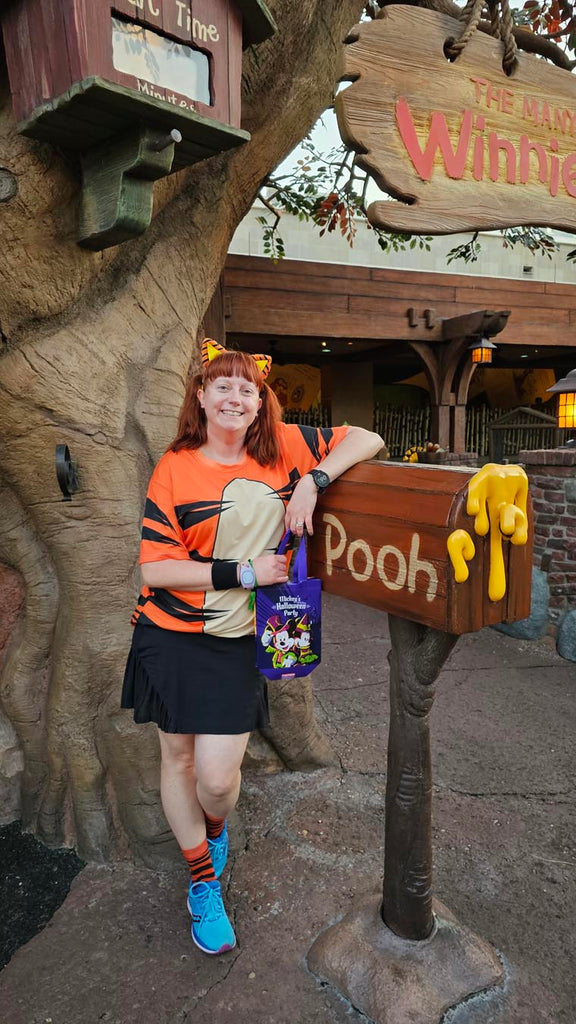 Kelly dressed in her Tigger costume standing next to Winnie the Pooh’s mailbox at the Magic Kingdom
