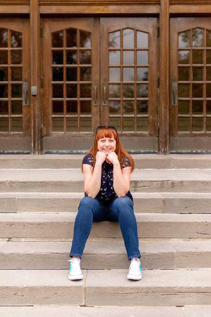 Kelly daydreaming while seated on steps