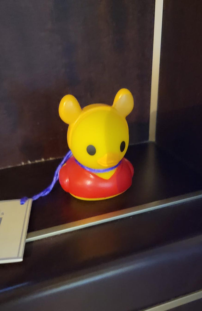 Rubber duck in a red shirt and wearing Mickey Ears hidden on a ship
